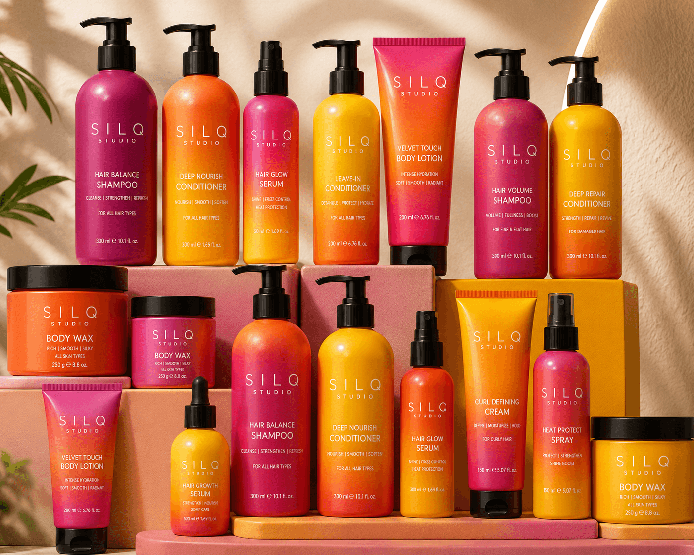 SILQ Studio shampoos, conditioners, hair serums, body lotions and body wax arranged on pink and orange display blocks